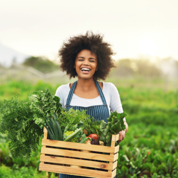 Woman holding box of vegetables